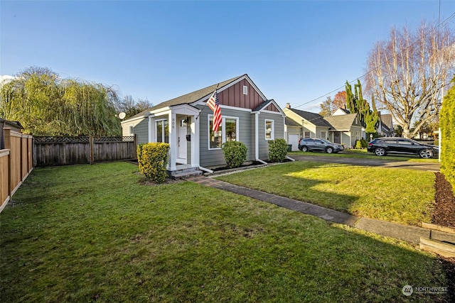 bungalow-style house featuring a front yard