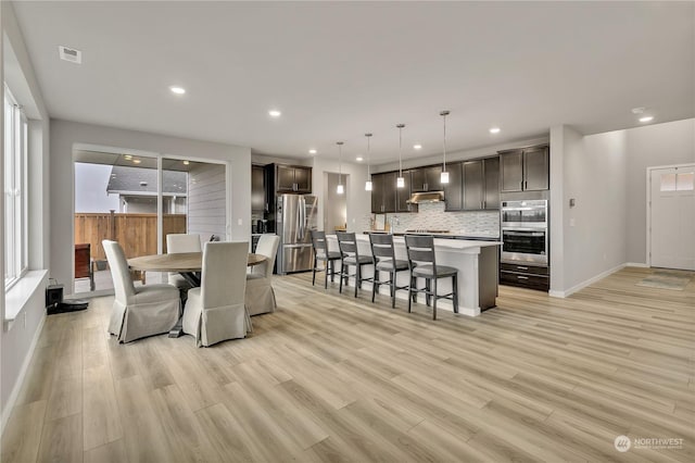 dining area with light hardwood / wood-style floors