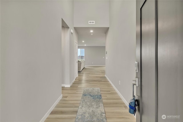 corridor with light hardwood / wood-style flooring