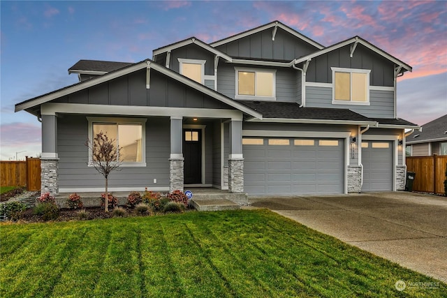 craftsman-style home featuring a lawn and a garage