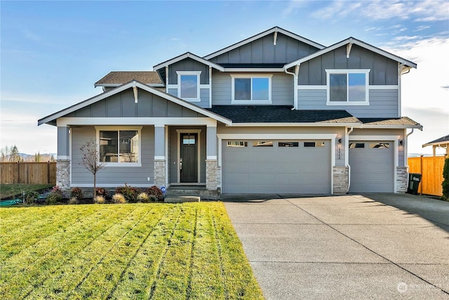 craftsman house with a front yard and a garage