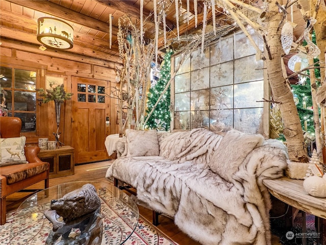 living area with wood ceiling, beamed ceiling, and wood-type flooring