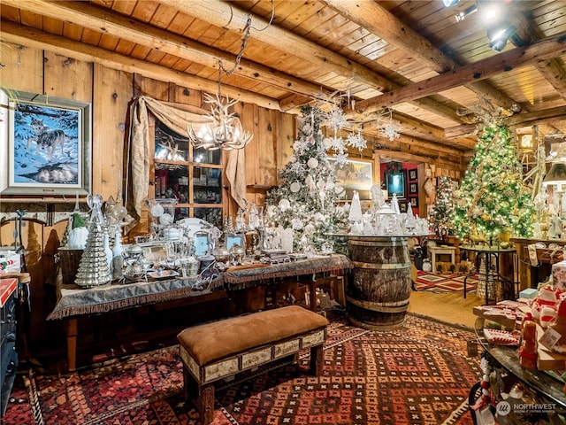 misc room featuring a notable chandelier, wood walls, wood ceiling, and beam ceiling