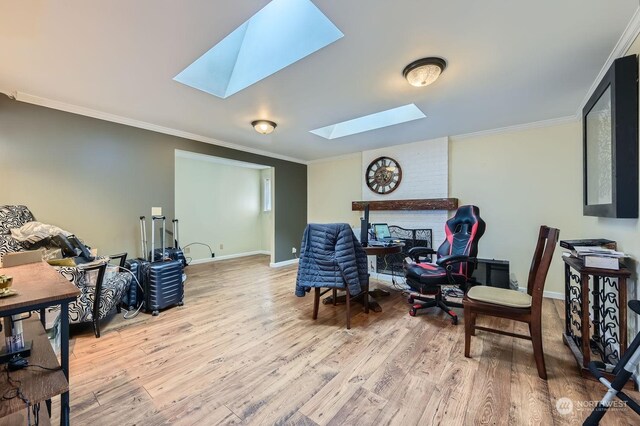 office area with a skylight, crown molding, and light hardwood / wood-style flooring