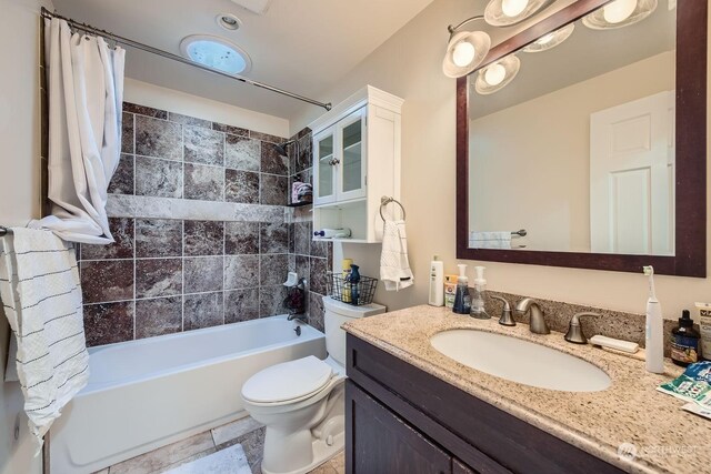 full bathroom with vanity, shower / tub combo, and toilet