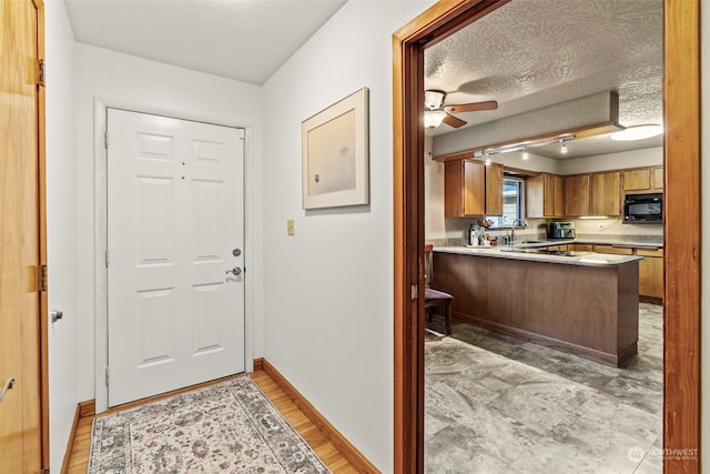 309 E State Route 4, Cathlamet, WA 98612 - doorway featuring ceiling fan, baseboards, and a sink