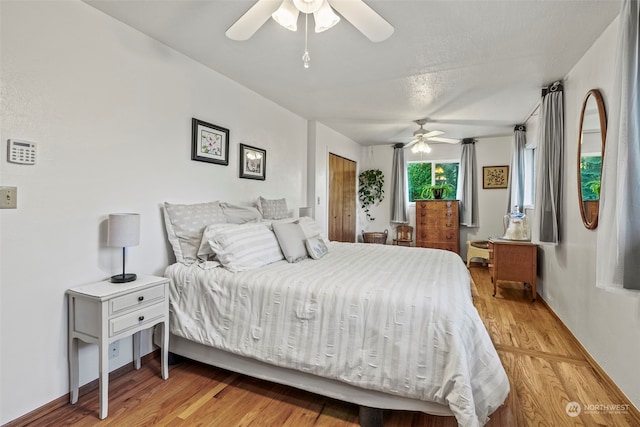 bedroom with light hardwood / wood-style flooring and ceiling fan