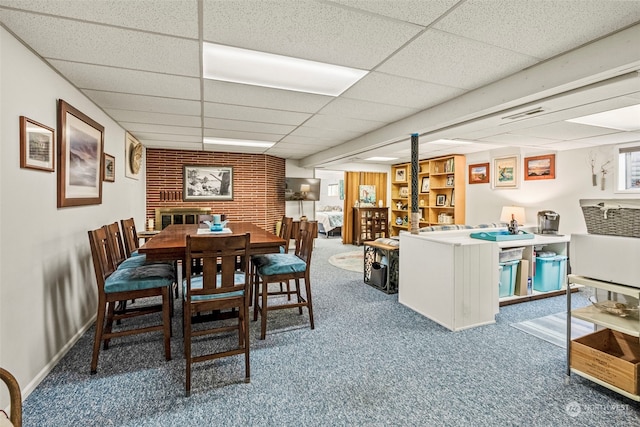 dining room featuring carpet flooring and a drop ceiling