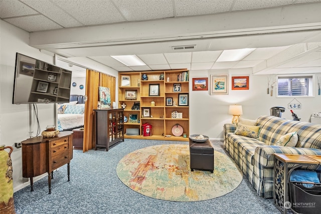 carpeted living room with a drop ceiling