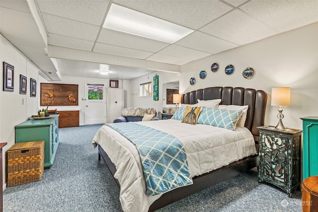 carpeted bedroom with a paneled ceiling