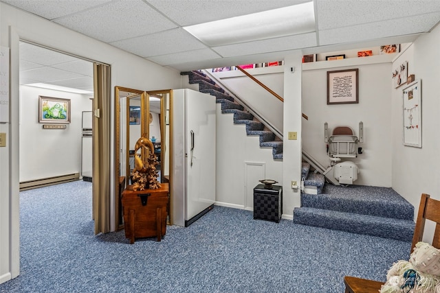 staircase with a paneled ceiling, carpet floors, and a baseboard heating unit