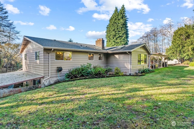 rear view of property with a yard