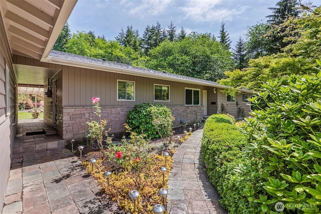 309 E State Route 4, Cathlamet, WA 98612 - view of exterior entry featuring roof with shingles and stone siding
