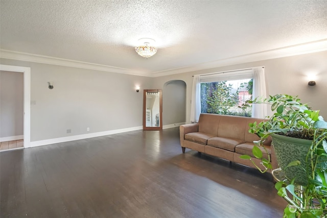 unfurnished living room featuring crown molding, dark hardwood / wood-style flooring, and a textured ceiling