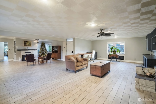 living room with light hardwood / wood-style floors and ceiling fan