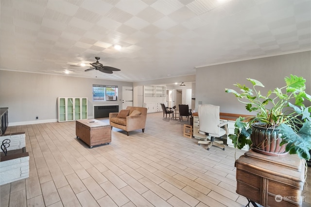 living room with ceiling fan, crown molding, and light wood-type flooring