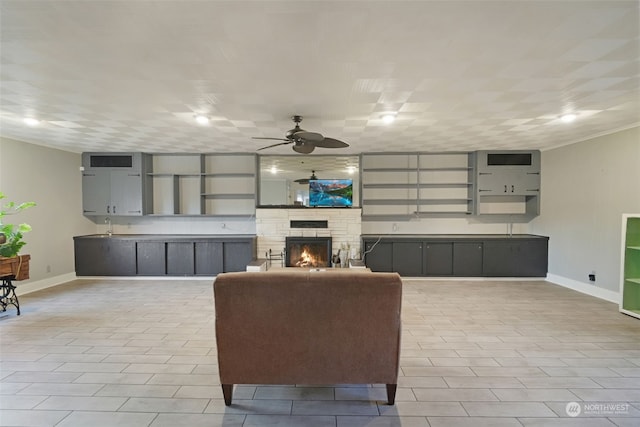 living room featuring ceiling fan, light tile patterned floors, and a fireplace