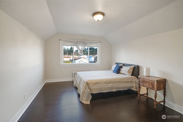 bedroom with dark wood-type flooring and vaulted ceiling