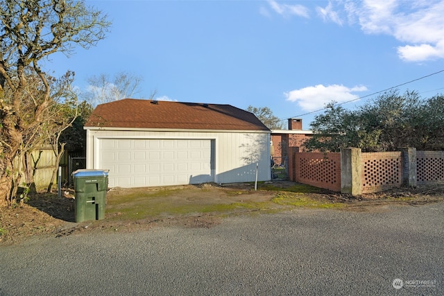 view of property exterior with an outbuilding and a garage