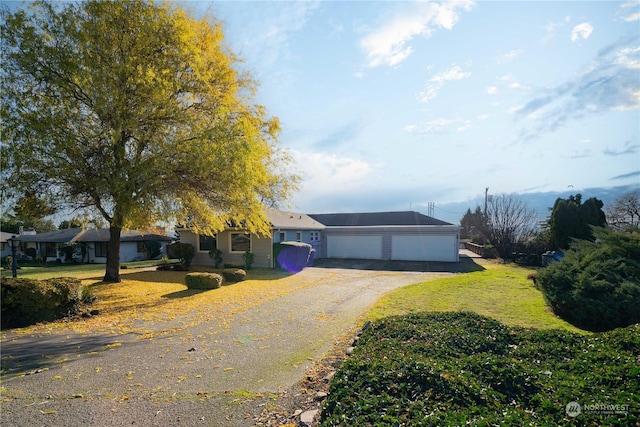 single story home featuring a garage and a front lawn