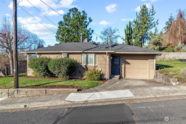 ranch-style house featuring a garage and a front lawn