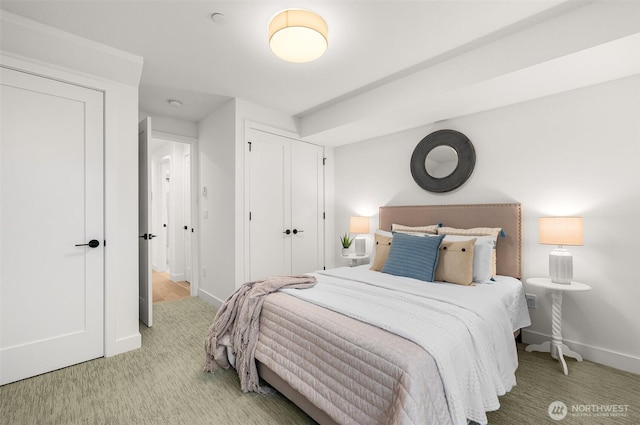 bedroom featuring baseboards and carpet