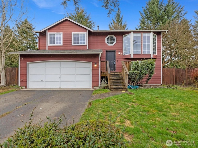 bi-level home featuring a garage, a front lawn, fence, and aphalt driveway