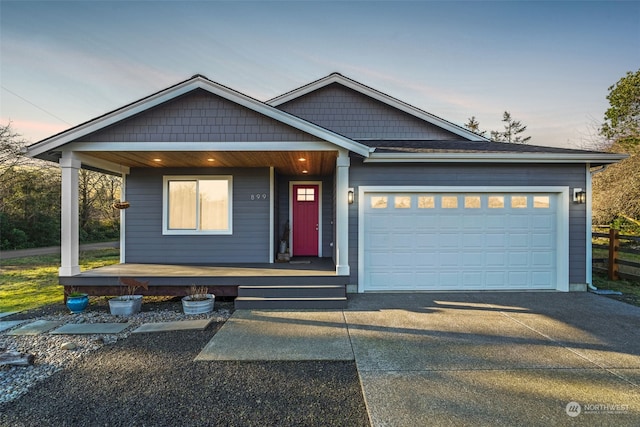 view of front facade featuring a porch and a garage