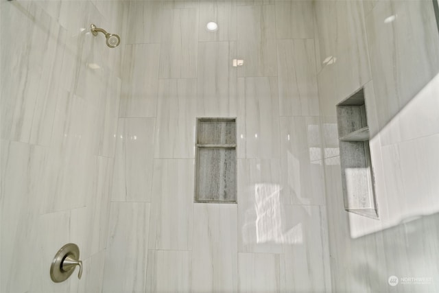 interior details with a tile shower