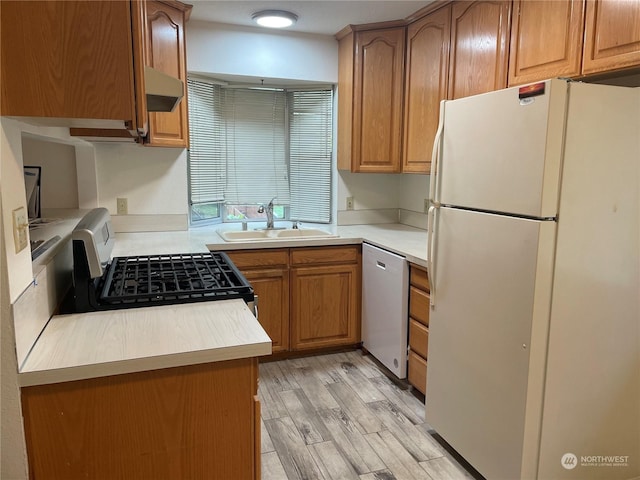 kitchen with sink, light hardwood / wood-style flooring, stainless steel dishwasher, white refrigerator, and range