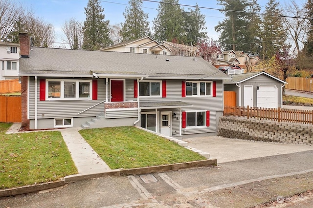 view of front of home with a garage, an outbuilding, and a front lawn