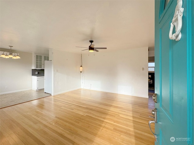 unfurnished living room with ceiling fan and light hardwood / wood-style flooring