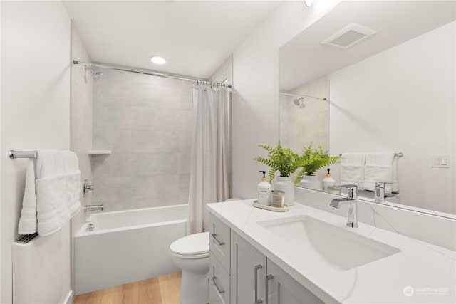 full bathroom featuring shower / bath combo, toilet, wood-type flooring, and vanity