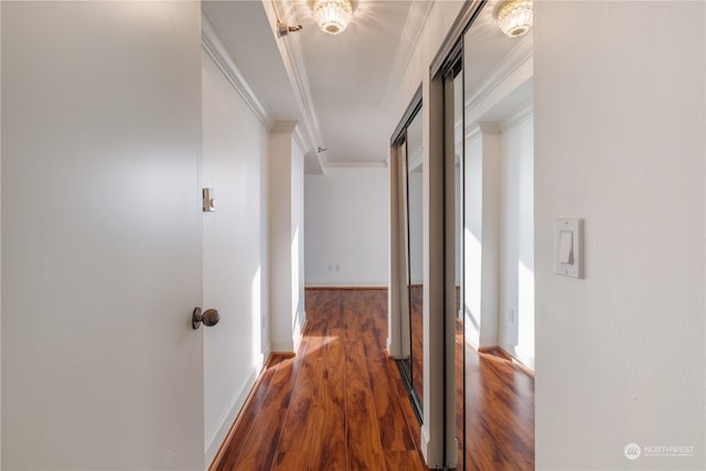 hall featuring crown molding and dark wood-type flooring