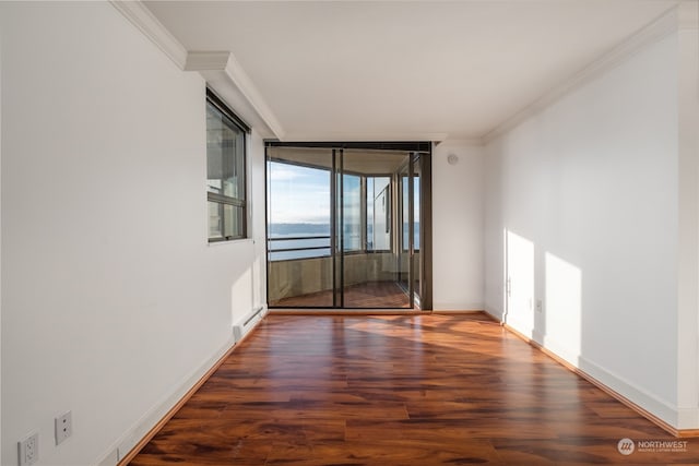 spare room with dark hardwood / wood-style flooring and ornamental molding