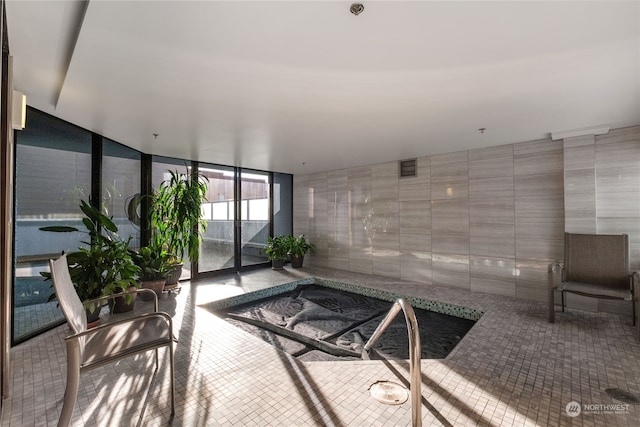 sunroom featuring a hot tub