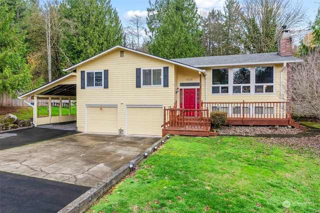 raised ranch with a wooden deck, a front lawn, a garage, and a carport