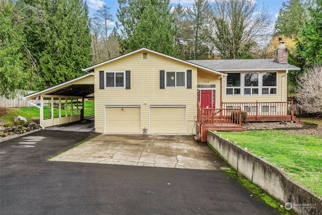 split foyer home with a wooden deck, a garage, and a carport