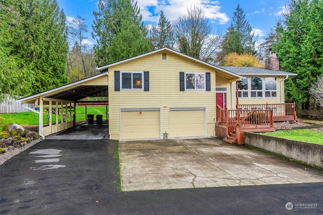 bi-level home featuring a carport, a deck, and a garage