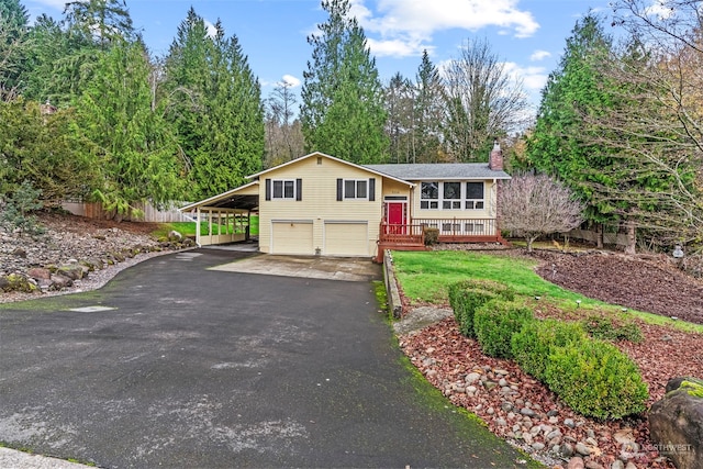 view of front of home featuring a garage, a carport, and a wooden deck