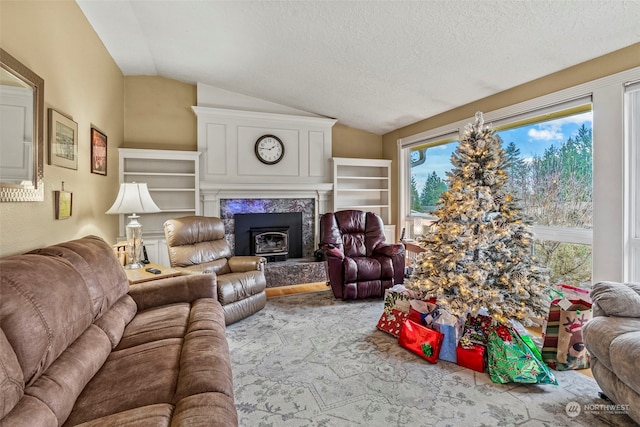 carpeted living room with a healthy amount of sunlight, a textured ceiling, and lofted ceiling