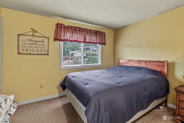 carpeted bedroom with a textured ceiling