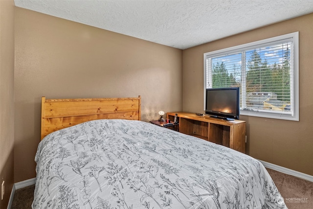 bedroom featuring a textured ceiling and carpet floors