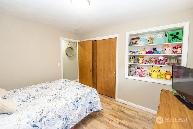 bedroom with a closet and light hardwood / wood-style floors