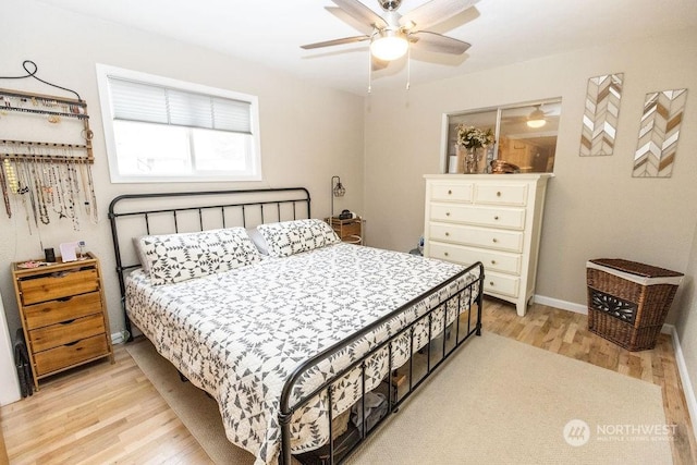 bedroom with ceiling fan and light hardwood / wood-style flooring