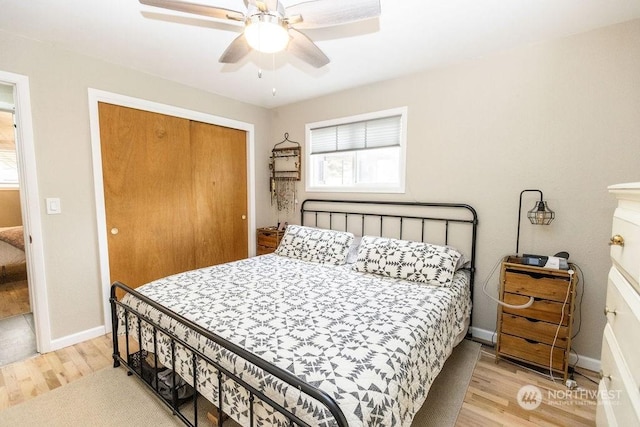 bedroom with a closet, ceiling fan, and light hardwood / wood-style flooring