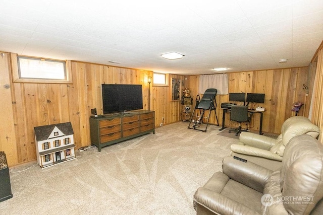 carpeted living room with wood walls