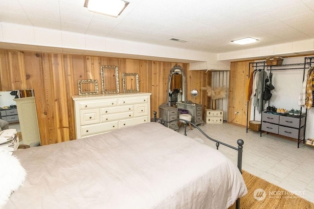 bedroom featuring wood walls