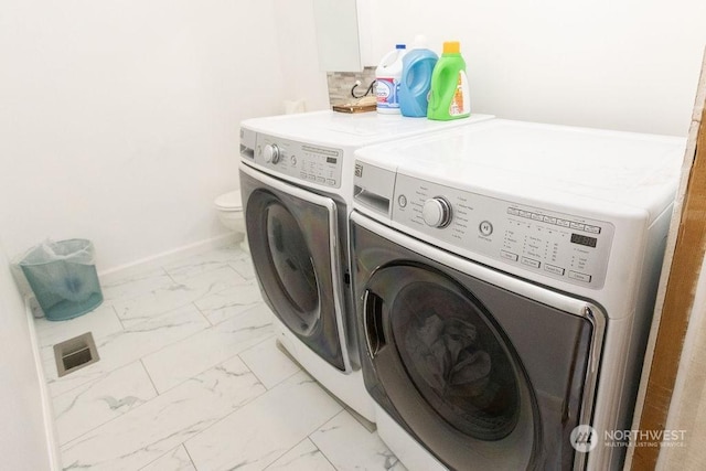 clothes washing area featuring washer and dryer