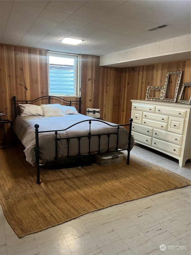 unfurnished bedroom featuring wooden walls